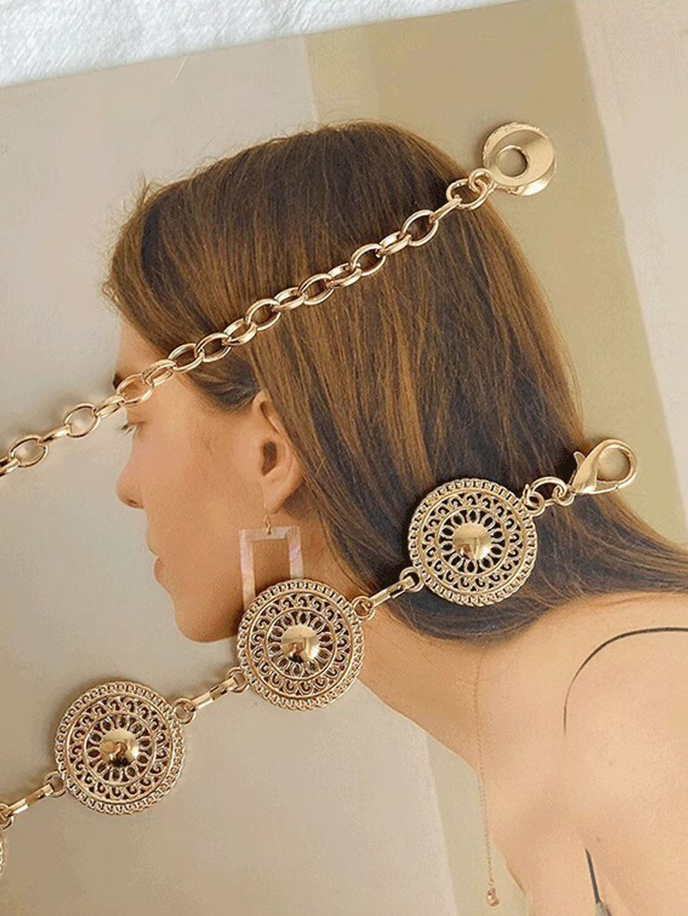 Women's gold-tone metal waist chain with a circular cutout design