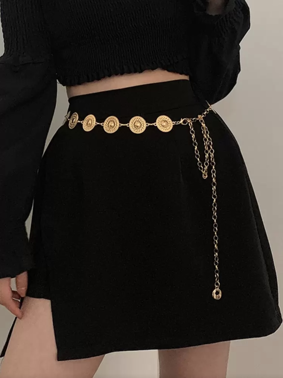 Women's gold-tone metal waist chain with a circular cutout design