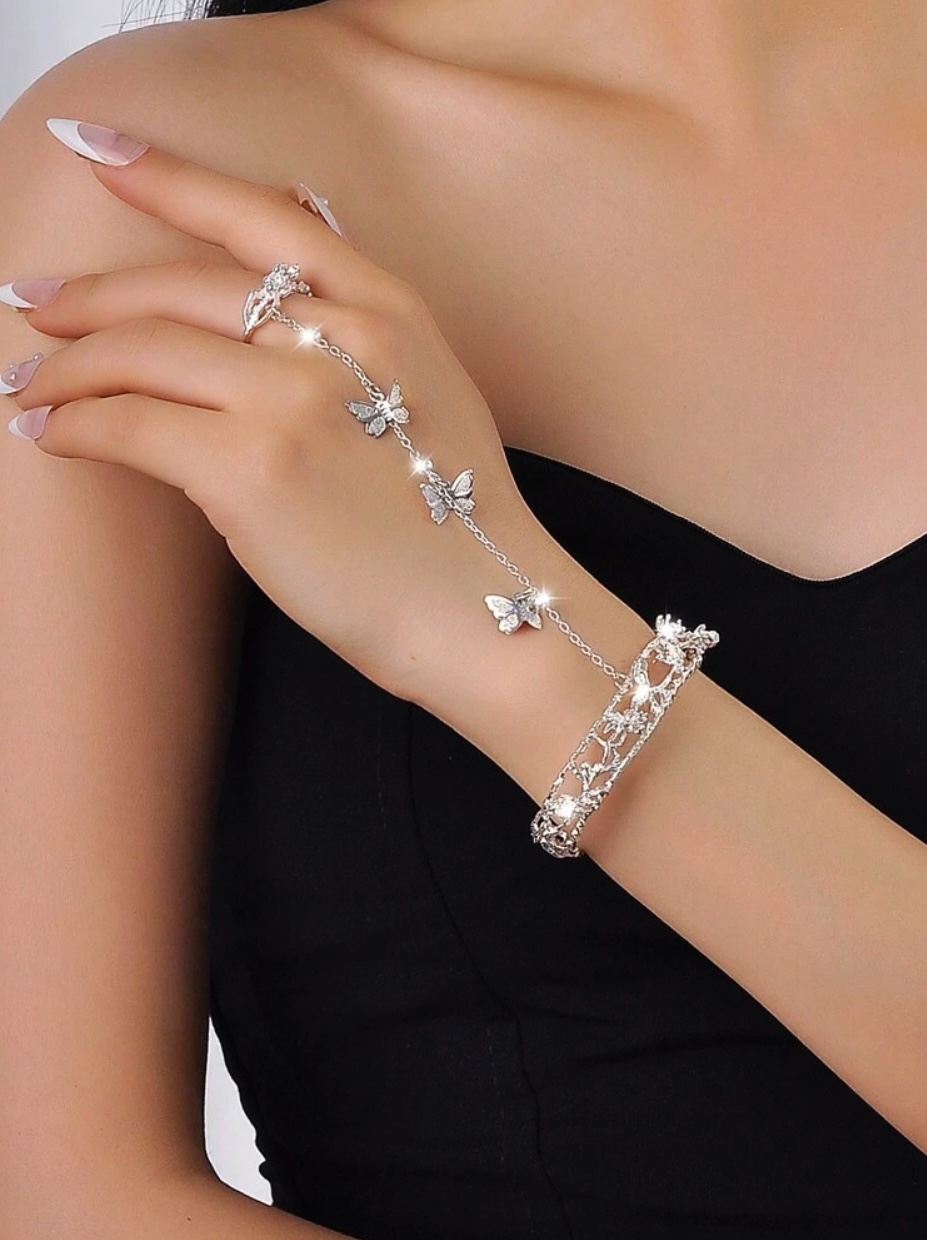 Adjustable butterfly chain finger ring in the style of a bracelet