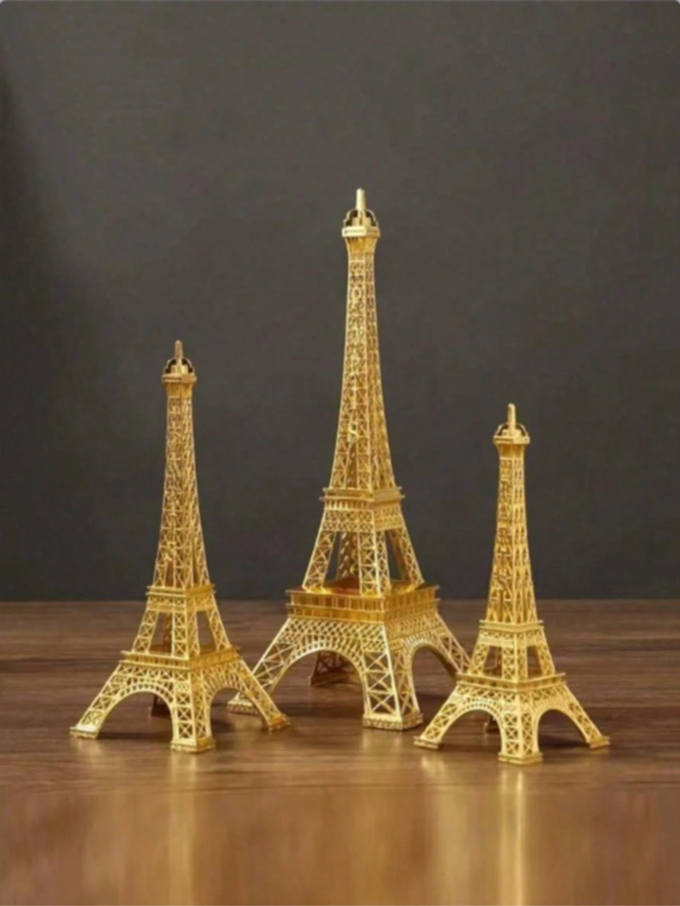 One piece of a sculpted gold Eiffel Tower model