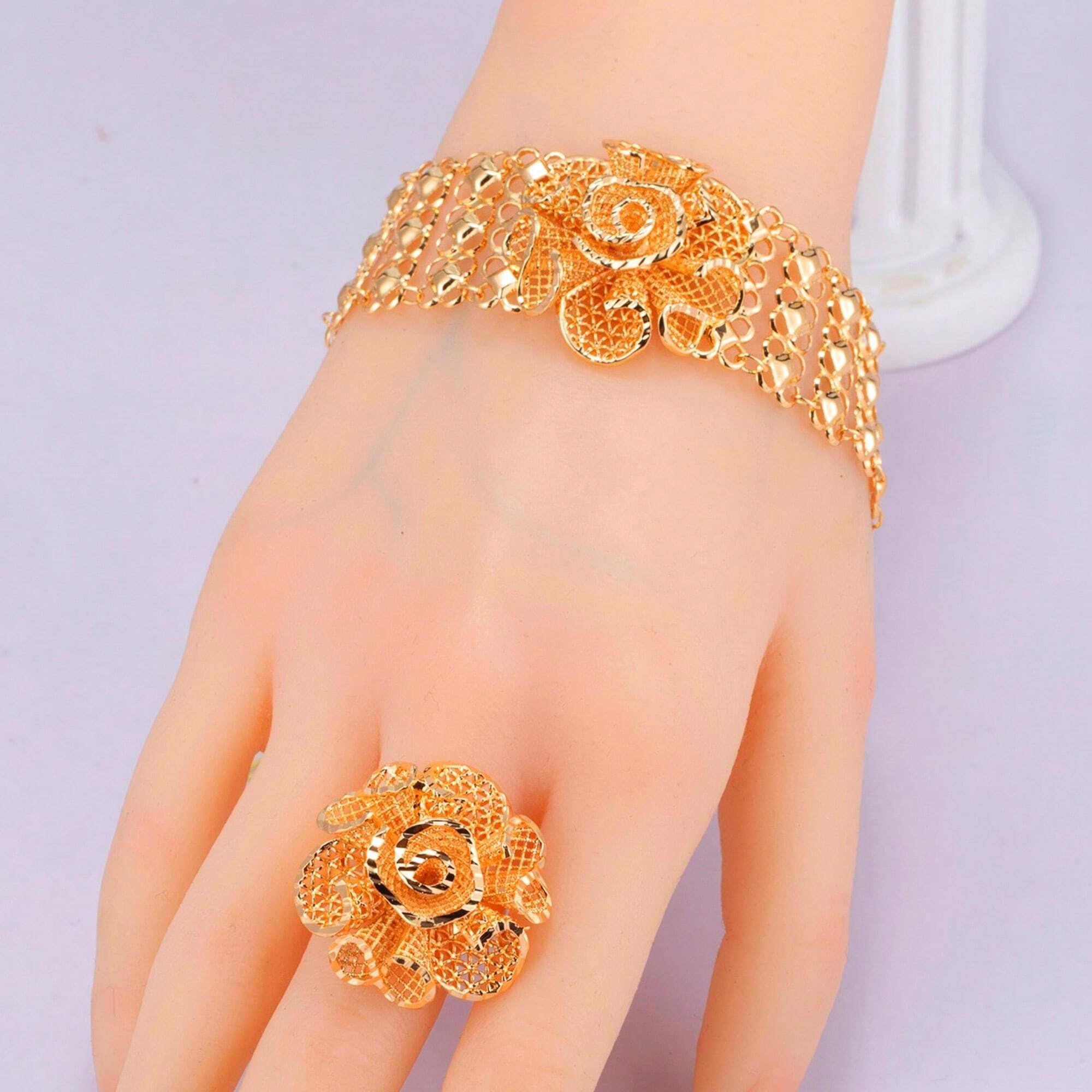 Accessory set consisting of a bracelet and ring made of copper plated with 18-karat gold.