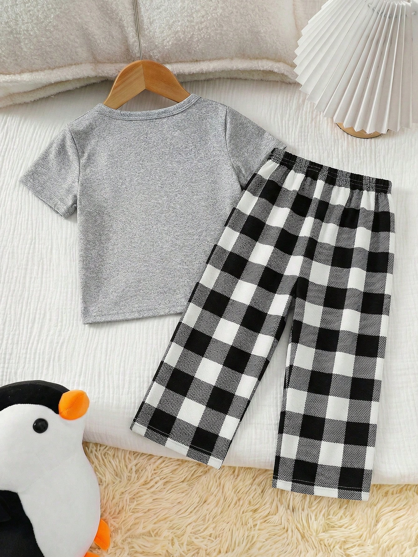 SHEIN Boys' 2-Piece Set: Loose-fitting plaid pajama pants and short-sleeved T-shirt with a cute cartoon penguin print