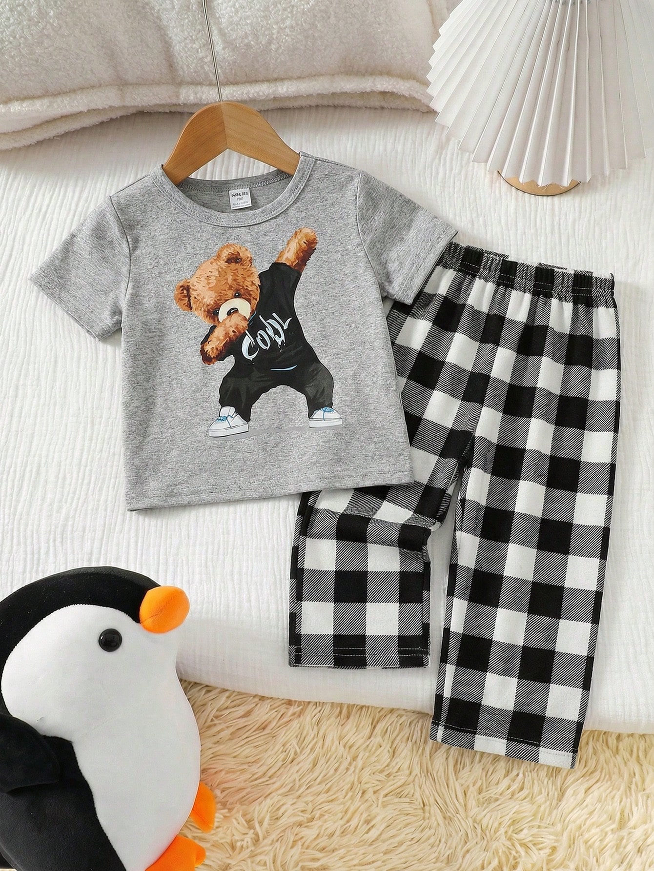 SHEIN Boys' 2-Piece Set: Loose-fitting plaid pajama pants and short-sleeved T-shirt with a cute cartoon penguin print